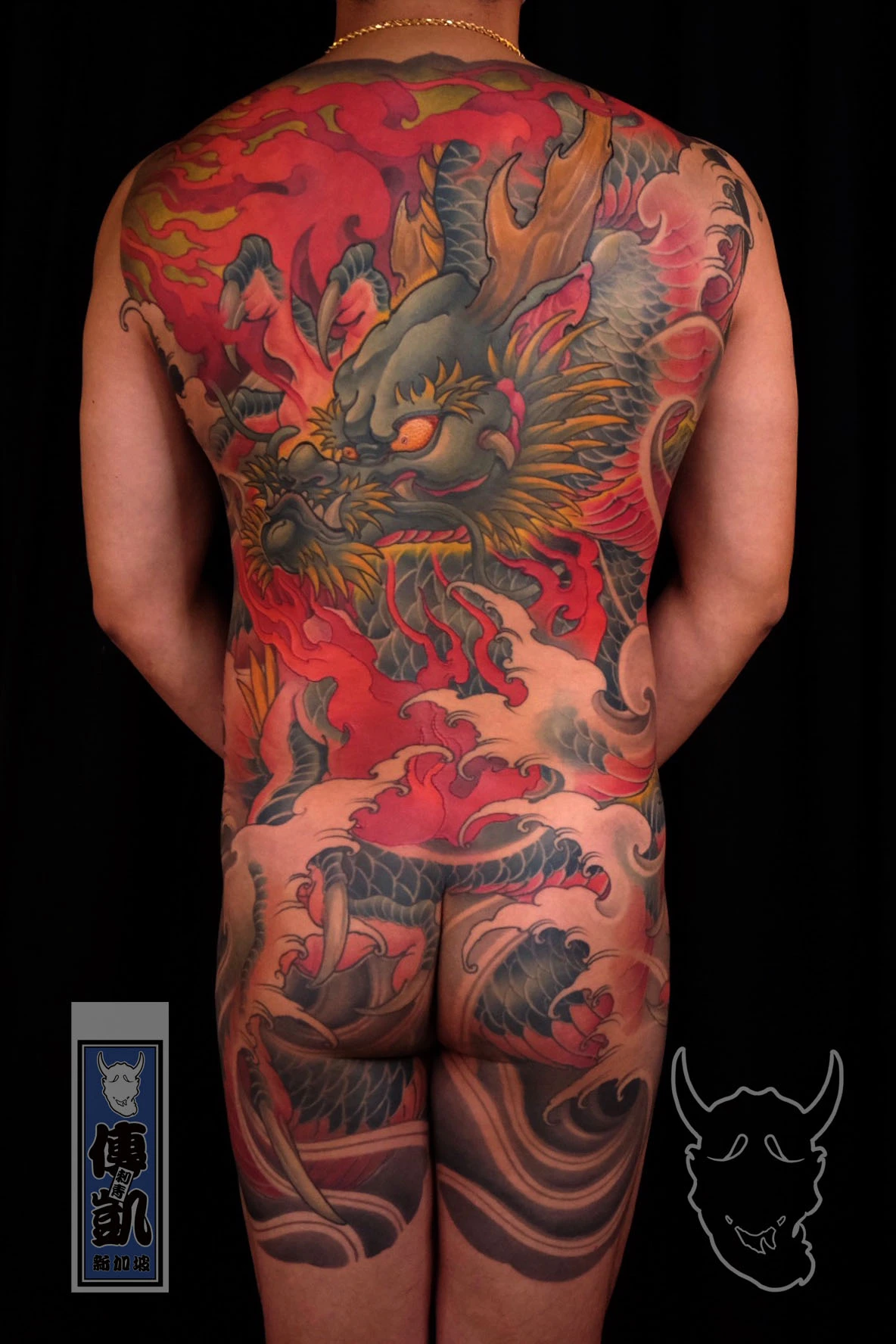 Japanese full back tattoo of a dragon surrounded by flames and waves, symbolizing power, courage, and spiritual transformation in Irezumi art.
