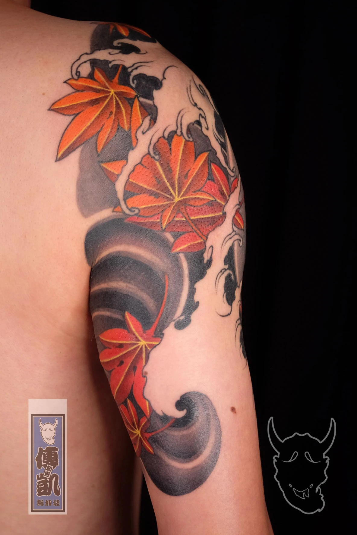 Japanese wave and maple leaf tattoo design on upper arm , traditional Irezumi style full sleeve featuring flowing water patterns and falling maple leaves
