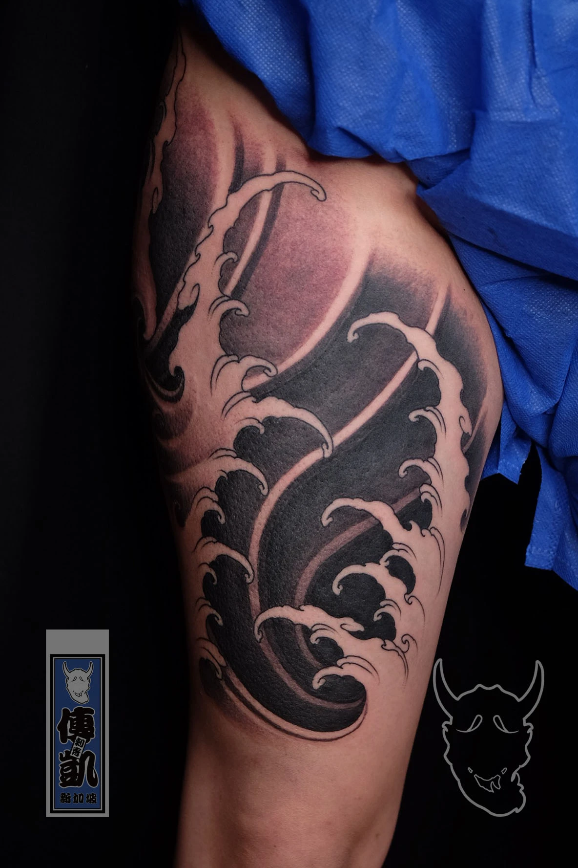 New Traditional Japanese leg tattoo in black and grey with flowing wave patterns, symbolizing strength and fluid motion. CK Tattoo Singapore.