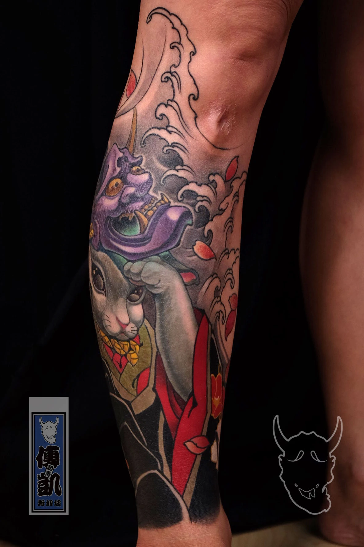 Japanese Usagi rabbit and purple Hannya mask leg tattoo with flowing waves and gold kimono details, representing duality and balance. Artwork by CK Tattoo Singapore