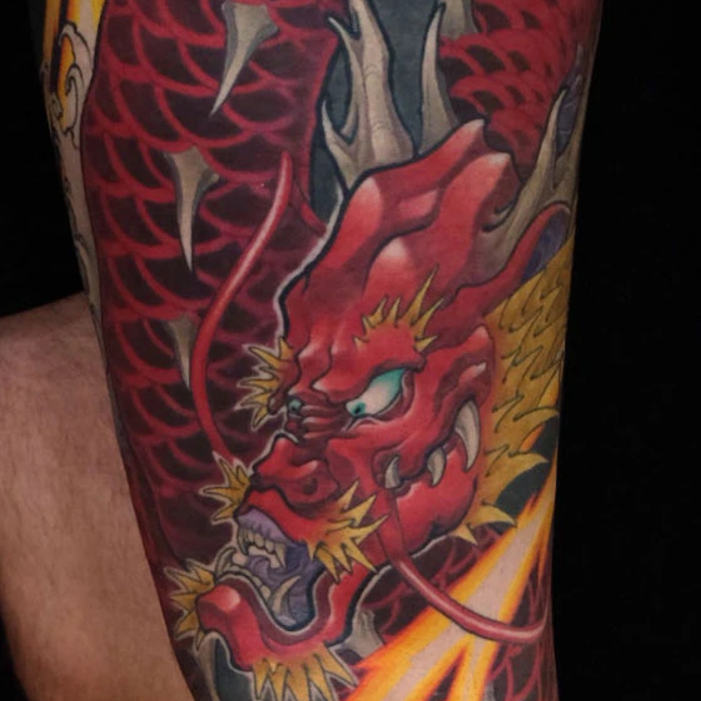 Japanese red dragon full leg sleeve tattoo with yellow flames and waves by CK Tattoo Singapore
