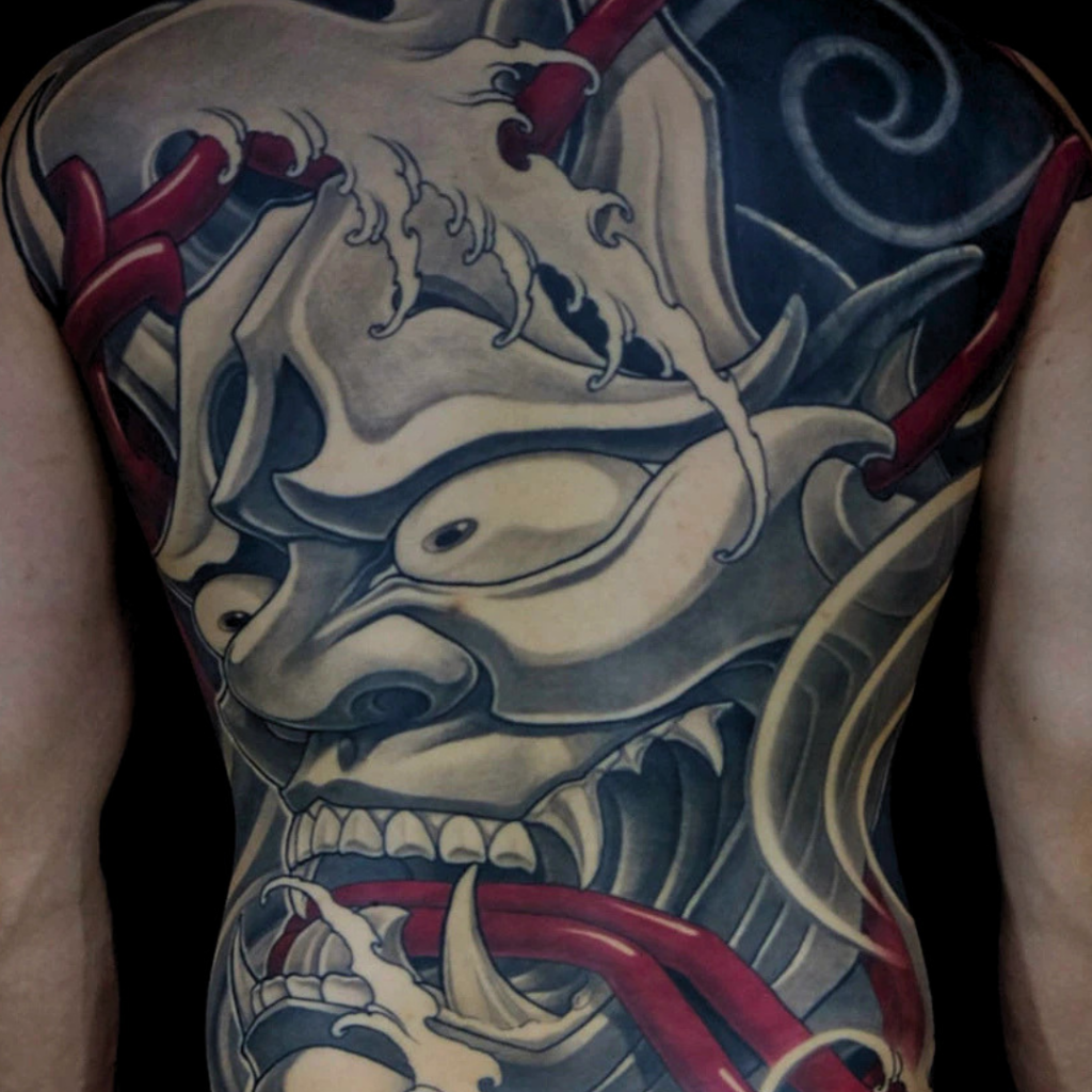 Black and grey Japanese hannya mask full back tattoo with red rope and waves by CK Tattoo Singapore